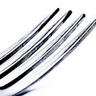 Americans hold their fork in their: